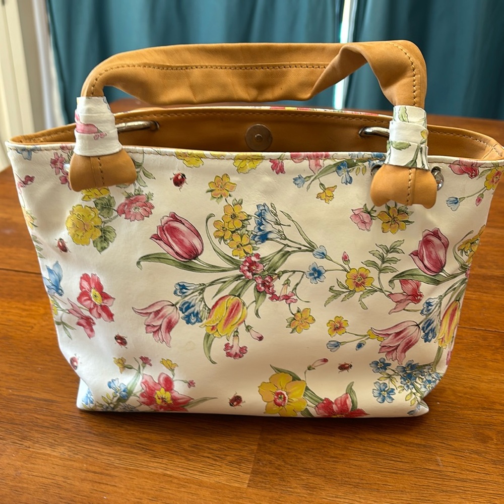 White leather handbag with flowers.